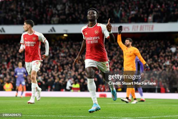 Bukayo Saka of Arsenal celebrates scoring his team's first goal during the Premier League match between Arsenal FC and Liverpool FC at Emirates...