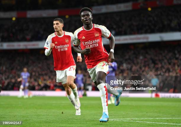 Bukayo Saka of Arsenal celebrates scoring his team's first goal during the Premier League match between Arsenal FC and Liverpool FC at Emirates...