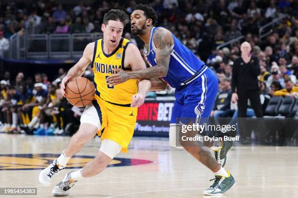 McConnell of the Indiana Pacers dribbles the ball while being guarded by Malik Monk of the Sacramento Kings in the third quarter at Gainbridge...