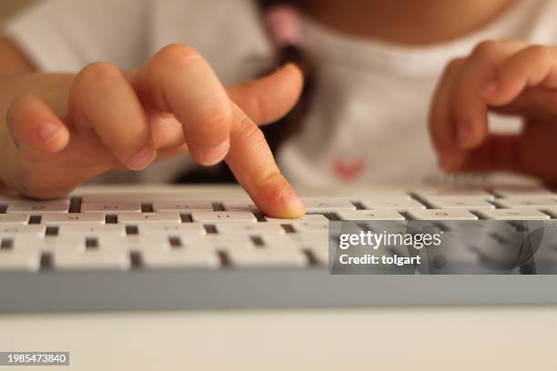 little girl uses computer keyboard - child laptop hands stock pictures, royalty-free photos & images