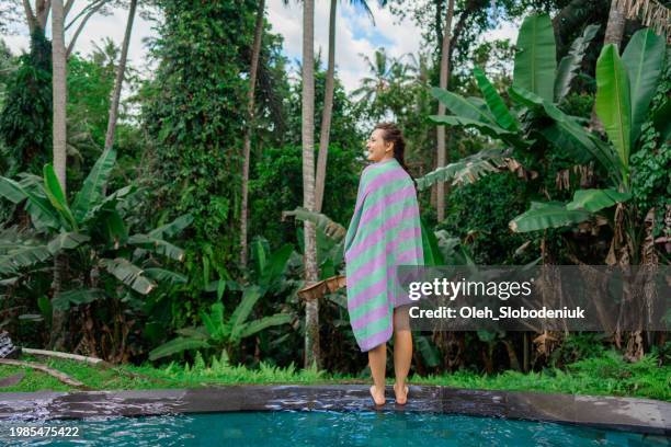 woman in towel after the swim in the pool - wrapped in a towel stock pictures, royalty-free photos & images