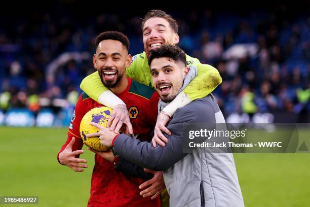 Pedro Neto of Wolverhampton Wanderers presents Matheus Cunha with the match ball after he scored a hat trick during the Premier League match between...