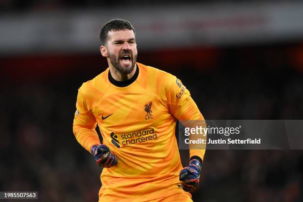 Alisson Becker of Liverpool celebrates his team's first goal, an own-goal scored by Gabriel of Arsenal during the Premier League match between...
