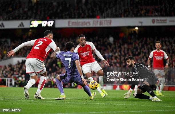Luis Diaz of Liverpool has a shot which later results in an own-goal scored by Gabriel of Arsenal during the Premier League match between Arsenal FC...