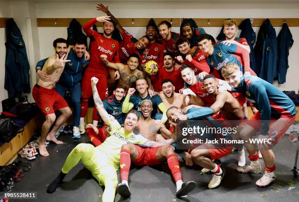 Wolves players celebrate as they pose for a team photo in the dressing room following victory in the Premier League match between Chelsea FC and...