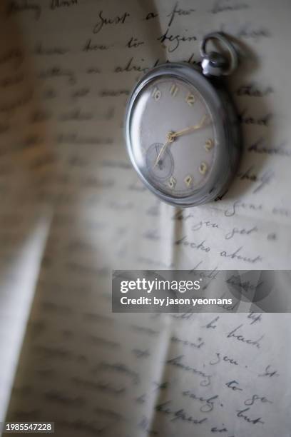 watch and letter - moment of silence stock pictures, royalty-free photos & images