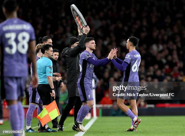 Andrew Robertson of Liverpool replaces Trent Alexander-Arnold during the Premier League match between Arsenal FC and Liverpool FC at Emirates Stadium...