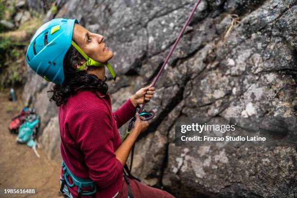female climber preparing to climb a mountain - belaying stock pictures, royalty-free photos & images