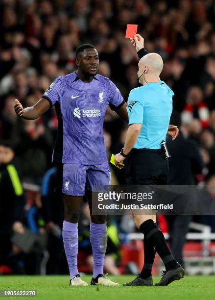 Ibrahima Konate of Liverpool is shown a red card by Referee Anthony Taylor following a second yellow card during the Premier League match between...