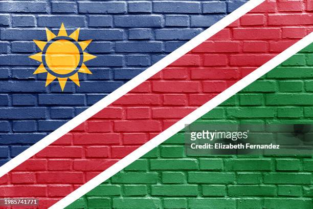 namibia flag on brick wall - namibian cultures stock pictures, royalty-free photos & images