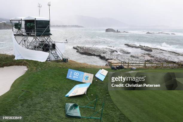 High winds blow against television towers and course signage during the delayed final round start the AT&T Pebble Beach Pro-Am at Pebble Beach Golf...