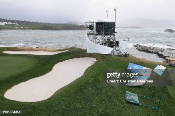 High winds blow against television towers and course signage during the delayed final round start the AT&T Pebble Beach Pro-Am at Pebble Beach Golf...