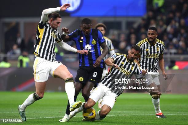Marcus Thuram of FC Internazionale is tackled by Adrien Rabiot and Danilo of Juventus during the Serie A TIM match between FC Internazionale and...