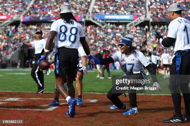 CeeDee Lamb of the Dallas Cowboys and NFC celebrates with teammates after catching a pass for a touchdown during the first quarter of the 2024 NFL...