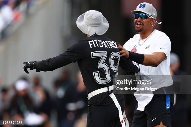 Jalen Hurts of the Philadelphia Eagles and NFC talks with Minkah Fitzpatrick of the Pittsburgh Steelers and AFC runs during the first quarter of the...