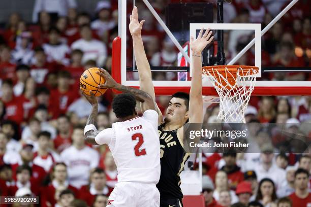 Zach Edey of the Purdue Boilermakers defends AJ Storr of the Wisconsin Badgers going up for a shot in the first half of the game at Kohl Center on...