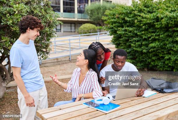 cheerful diverse students studying and chatting outside campus - laptop netbook stock pictures, royalty-free photos & images