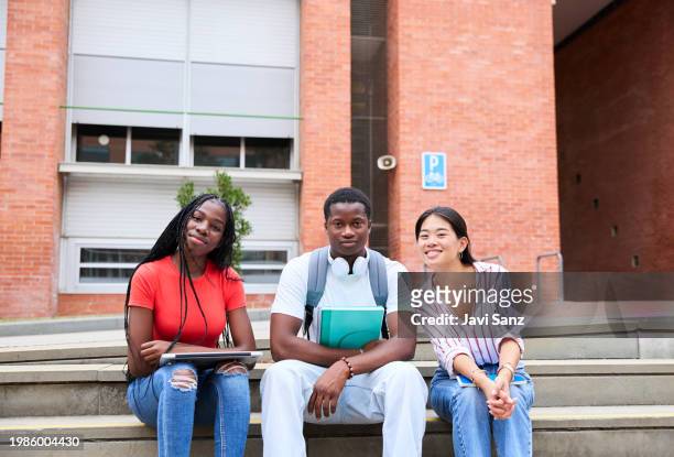 portrait of a group of young multiethnic students smiling at college - laptop netbook stock pictures, royalty-free photos & images