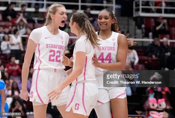 Hannah Jump of the Stanford Cardinal is congratulated by Cameron Brink and Kiki Iriafen after Jump made a three-point shot against the UCLA Bruins in...