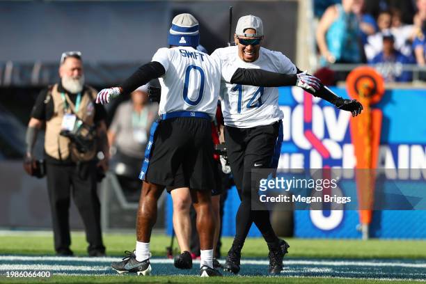 Andre Swift of the Philadelphia Eagles and Amon-Ra St. Brown of the Detroit Lions and NFC celebrate after a score during the first half of the 2024...