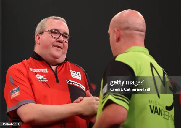 Stephen Bunting is congratulated by Michael van Gerwen after winning the 2024 PDC Cazoo Masters Darts Final at Marshall Arena on February 04, 2024 in...