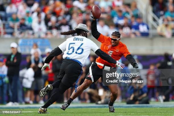 Ja’Marr Chase of the Cincinnati Bengals and AFC tries to avoid having his flag pulled by Demario Davis of the New Orleans Saints and NFC during the...
