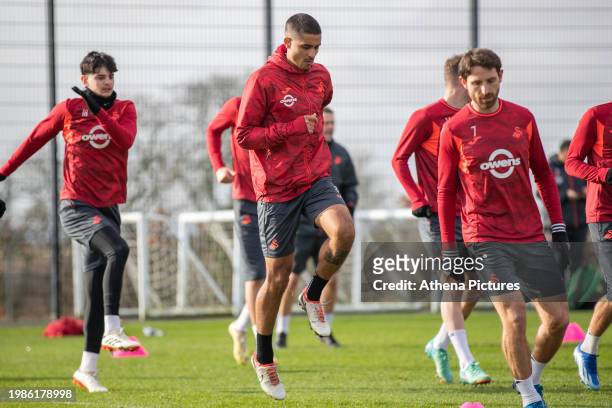Charlie Patino , Kyle Naughton and Joe Allen warm up during the Swansea City Training Session at The Fairwood Training Ground on February 07, 2024 in...