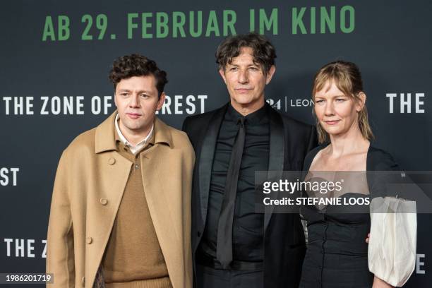 German actors Christian Friedel and Sandra Hueller and English director and screenwriter Jonathan Glazer pose on the red carpet prior to a screening...