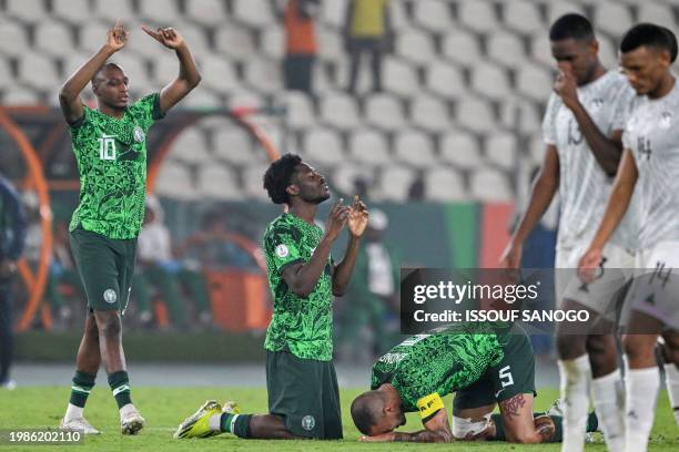 Nigeria's players celebrate the victory at the end of the Africa Cup of Nations 2024 semi-final football match between Nigeria and South Africa at...