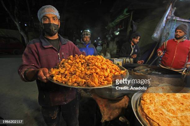 Man carries freshly fried snacks outside the Hazratbal shrine on the occasion of Lailat al Miraj or Shab-e-Meraj in India-administered state of Jammu...