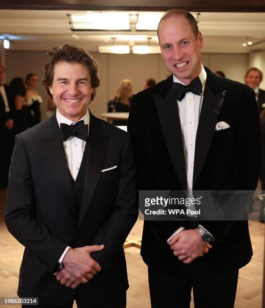 Britain's Prince William, Prince of Wales poses for a photo with US actor Tom Cruise at the London Air Ambulance Charity Gala Dinner at The OWO on...