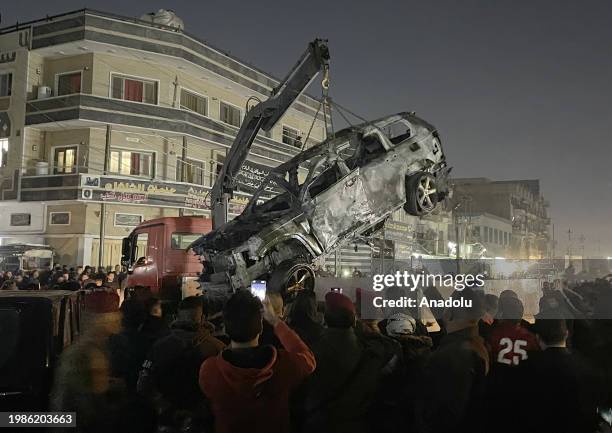 Crane lifts the wrecked car which has been targeted to kill the Senior commander Abu Baqir al-Saadi of Popular Mobilization Forces at eastern area of...