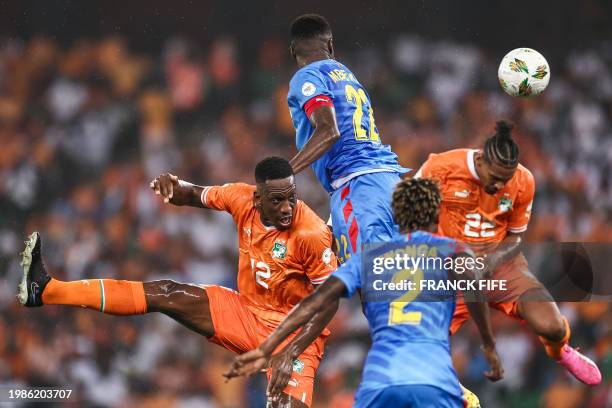Ivory Coast's defender Willy Boly fights for the ball with DR Congo's defender Chancel Mbemba during the Africa Cup of Nations 2024 semi-final...