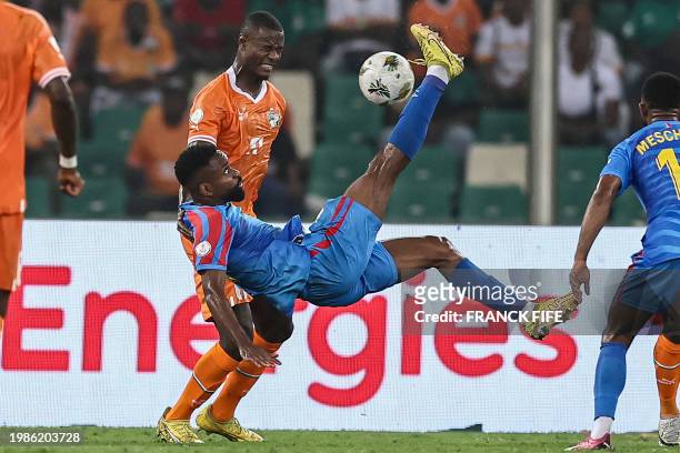 Congo's forward Cedric Bakambu fights for the ball with Ivory Coast's defender Evan Ndicka during the Africa Cup of Nations 2024 semi-final football...