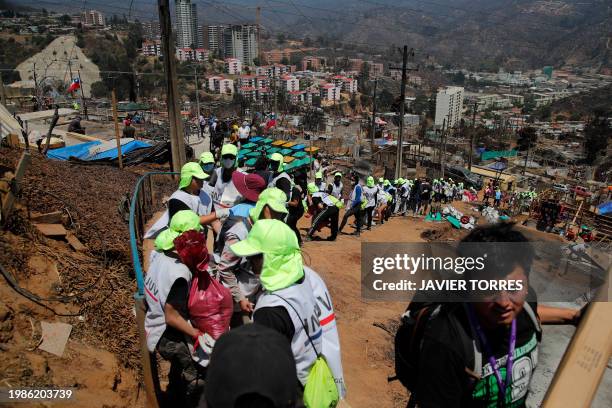 Volunteers deliver community aid to affected residents after a forest fire in the Poblacion Monte Sinai neighborhood in Viña Del Mar, Chile, on...