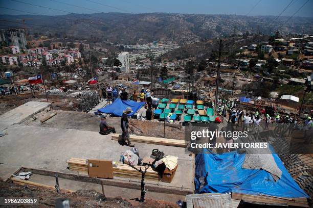 Residents camp on the land where their houses were destroyed after a forest fire in the Poblacion Monte Sinai neighborhood in Viña Del Mar, Chile, on...