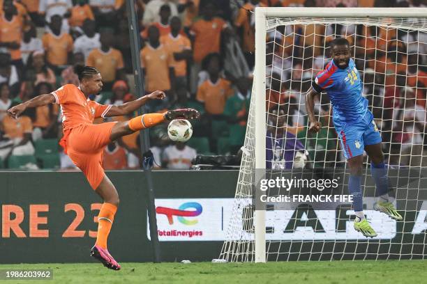 Ivory Coast's forward Sebastien Haller kicks to score his team's first goal during the Africa Cup of Nations 2024 semi-final football match between...