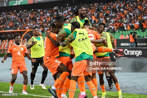 Ivory Coast's forward Sebastien Haller celebrates with teammates after scoring his team's first goal during the Africa Cup of Nations 2024 semi-final...