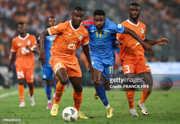 Ivory Coast's defender Evan Ndicka fights for the ball with DR Congo's forward Cedric Bakambu during the Africa Cup of Nations 2024 semi-final...