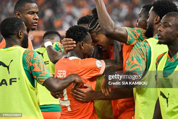 Ivory Coast's forward Sebastien Haller celebrates with Ivory Coast's midfielder Jean Michael Seri after scoring his team's first goal during the...