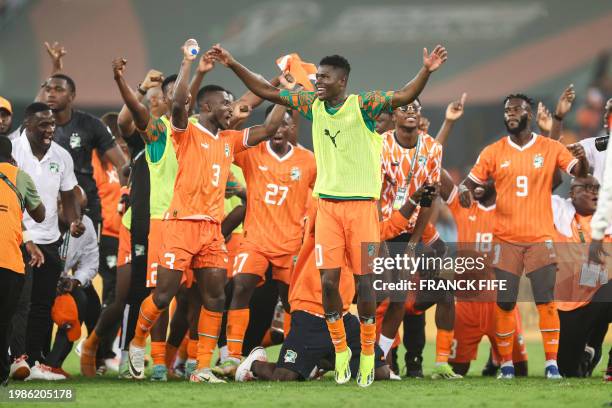 Ivory Coast's players celebrate after winning at the end of the Africa Cup of Nations 2024 semi-final football match between Ivory Coast and...