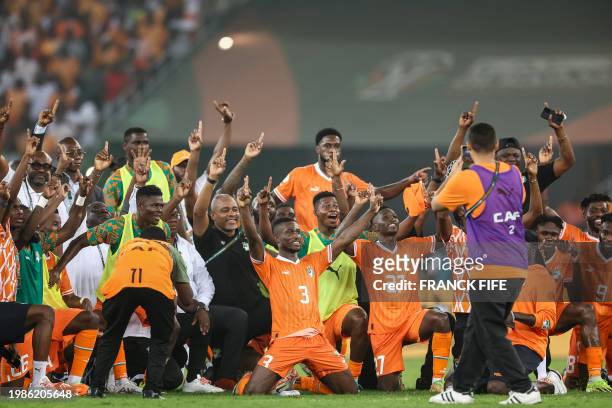 Ivory Coast's players celebrate after winning at the end of the Africa Cup of Nations 2024 semi-final football match between Ivory Coast and...