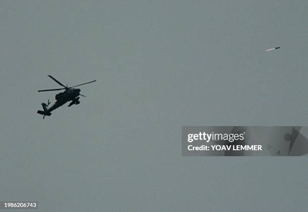 An Israeli Apache helicopter fires a missile 19 May 2004 towards the southern Gaza Strip refugee camp of Rafah during an attack which caused many...