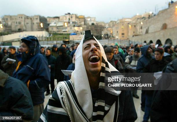 Jews pray in front of the wailing wall in Jerusalem's old city during a special mass prayer 19 February 2004. The mass prayer was organized in...