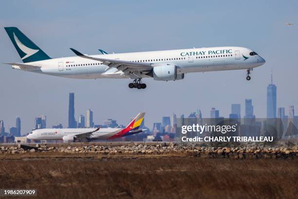 An Airbus A350 passenger aircraft of Cathay Pacific arrives from Hong Kong and an Airbus A350 passenger aircraft of Asiana Airlines prepares to take...