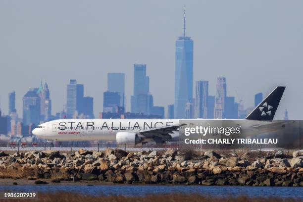 Boeing 777 passengers aircraft of Air India prepares to take off to New Delhi at JFK International Airport in New York as the Manhattan skyline looms...