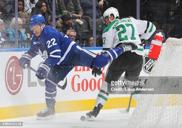 Mason Marchment of the Dallas Stars slams into Jake McCabe of the Toronto Maple Leafs during the third period in an NHL game at Scotiabank Arena on...
