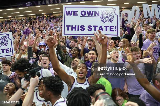Kansas State Wildcats head coach Jerome Tang and forward David N'Guessan celebrate in the student section after an overtime victory in a Big 12...