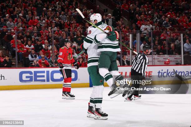 The Minnesota Wild celebrate after scoring on the Chicago Blackhawks in the third period at the United Center on February 07, 2024 in Chicago,...