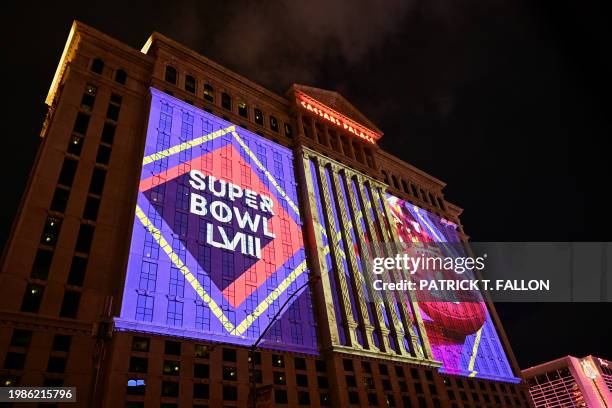 Super Bowl LVIII football logos are projected on the side of Caesars Entertainment, Inc.'s Caesars Palace Las Vegas Hotel and Casino ahead of Super...